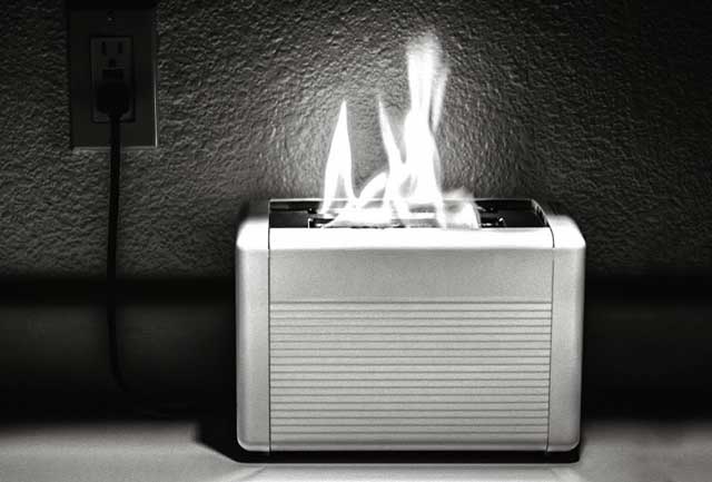 black and white photo of toaster on fire