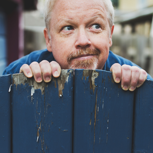 Mark A. Rayner, looking from behind a fence